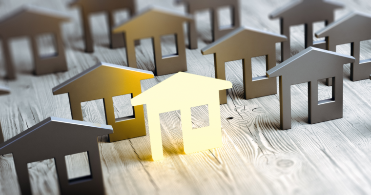 Golden house standing out among others - representing real estate investment opportunities